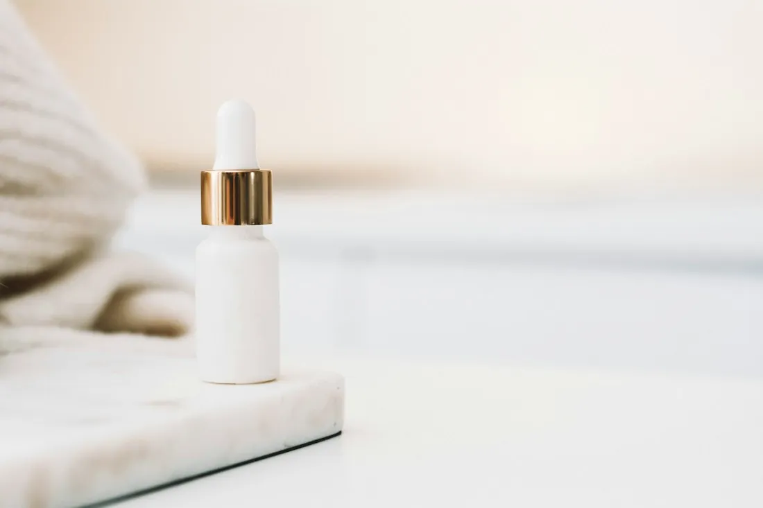 Skin care serum bottle on a marble tray